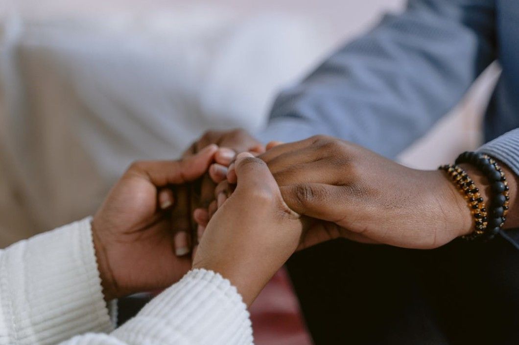 Family holding hands for compassionate funeral planning and grief support in Columbia, TN
