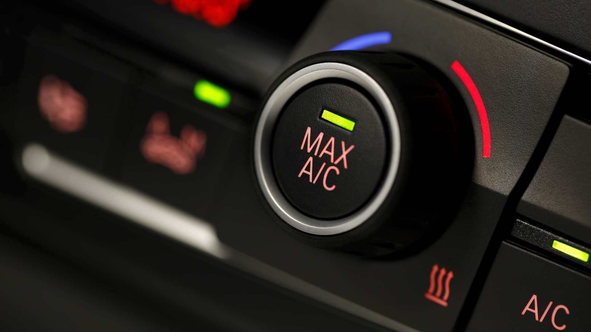 Car dashboard climate control knob labeled “MAX A/C” with red and blue temperature markings.