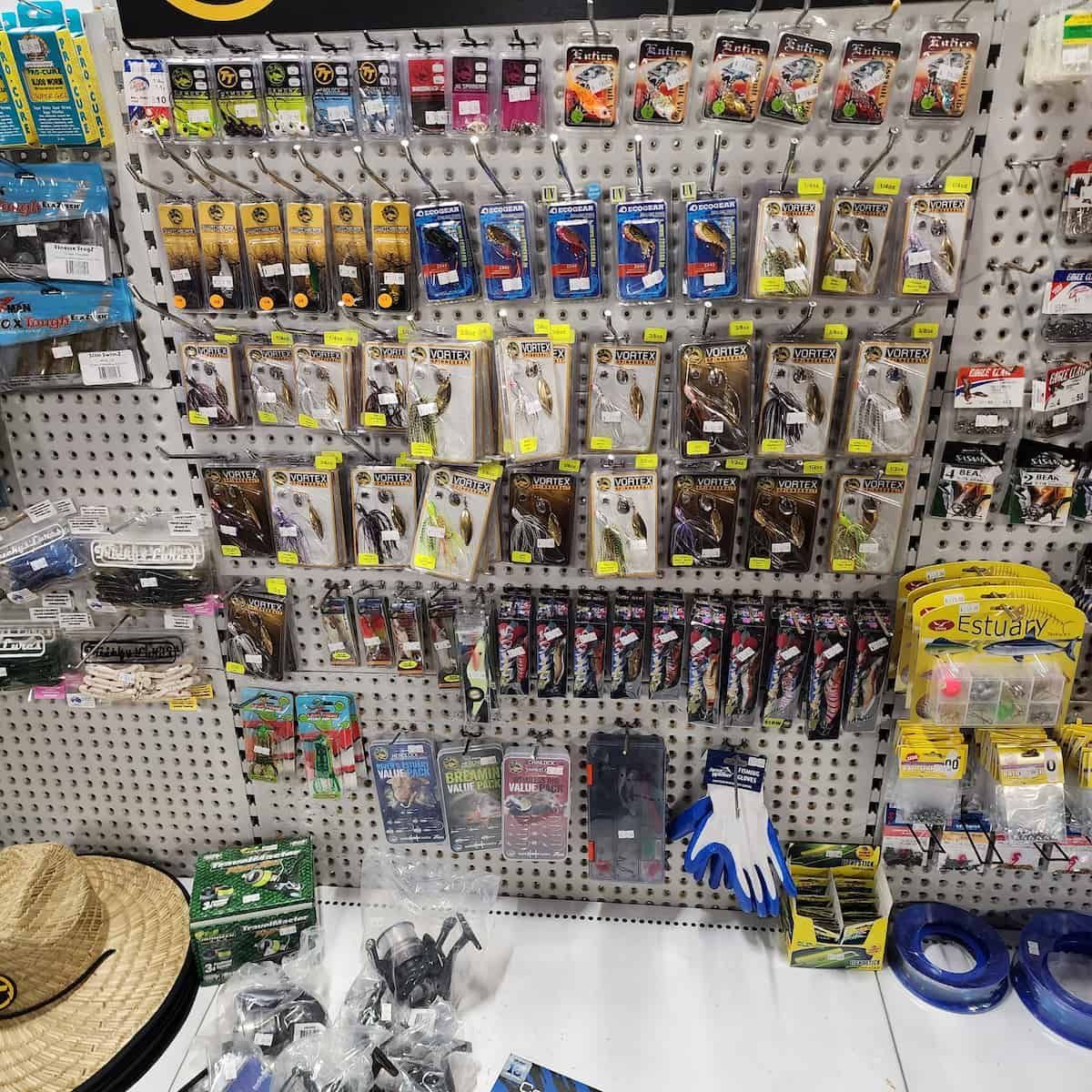 A Wall Filled With Lots Of Fishing Supplies And A Straw Hat — Murgon Auto Parts & Outdoors In Murgon, QLD