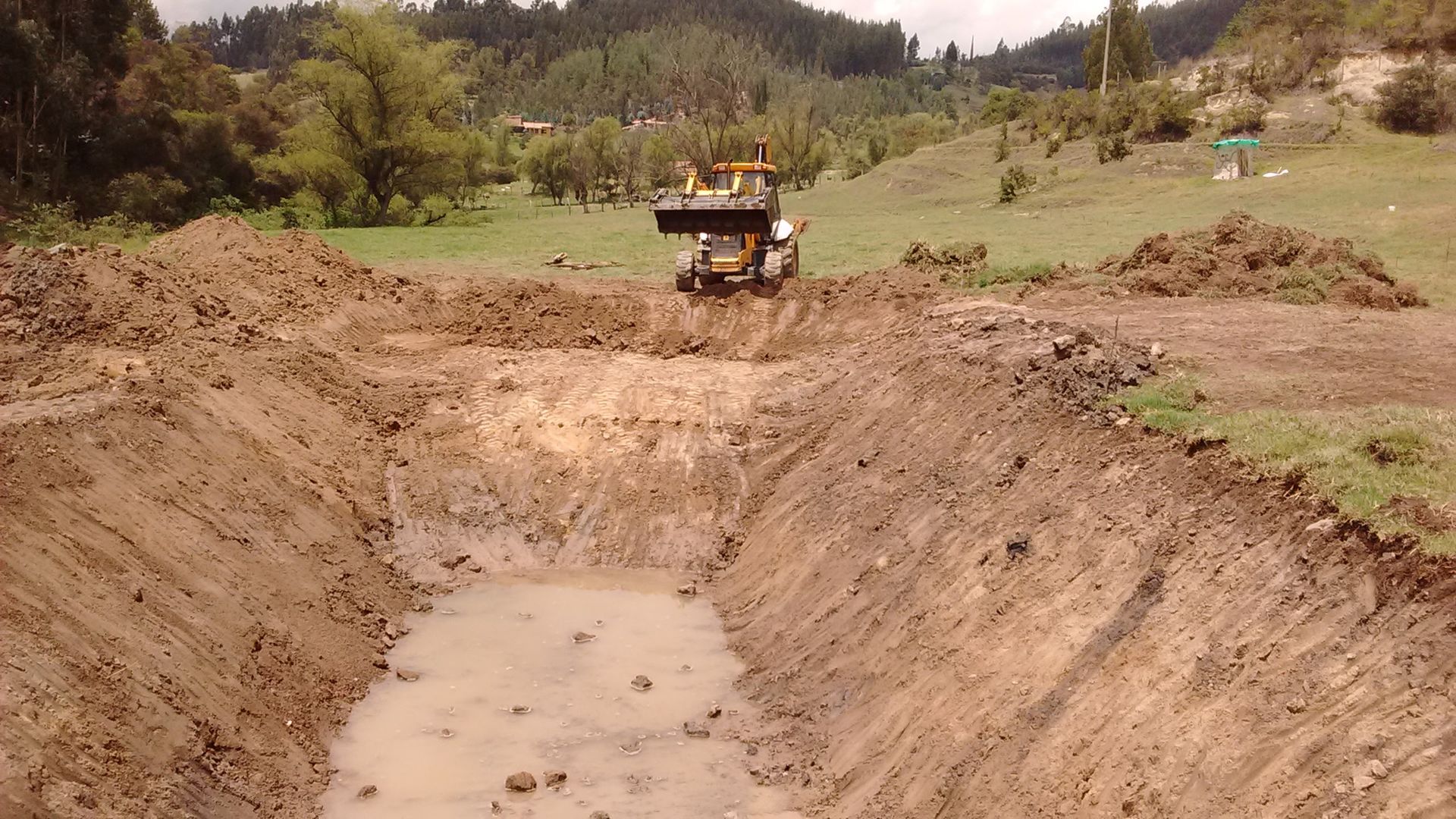 A bulldozer is digging a hole in the dirt
