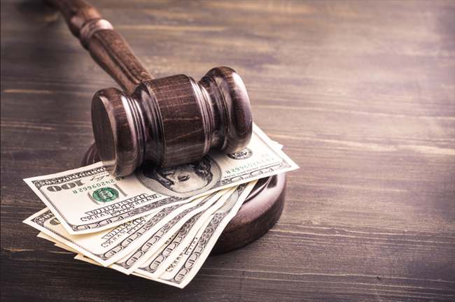 Gavel and some dollars banknotes on wooden table, symbolizing a bankruptcy law attorney Detroit, MI.