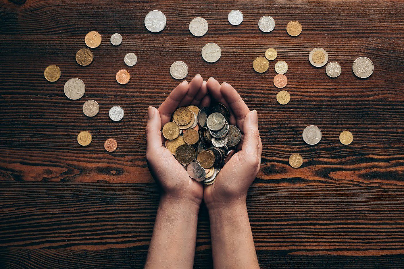 Woman Holding Coins — Livonia, MI — Charles J Schneider PC