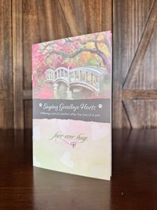 Booklet with bridge and pink foliage, text: Saying Goodbye, Forever loving.