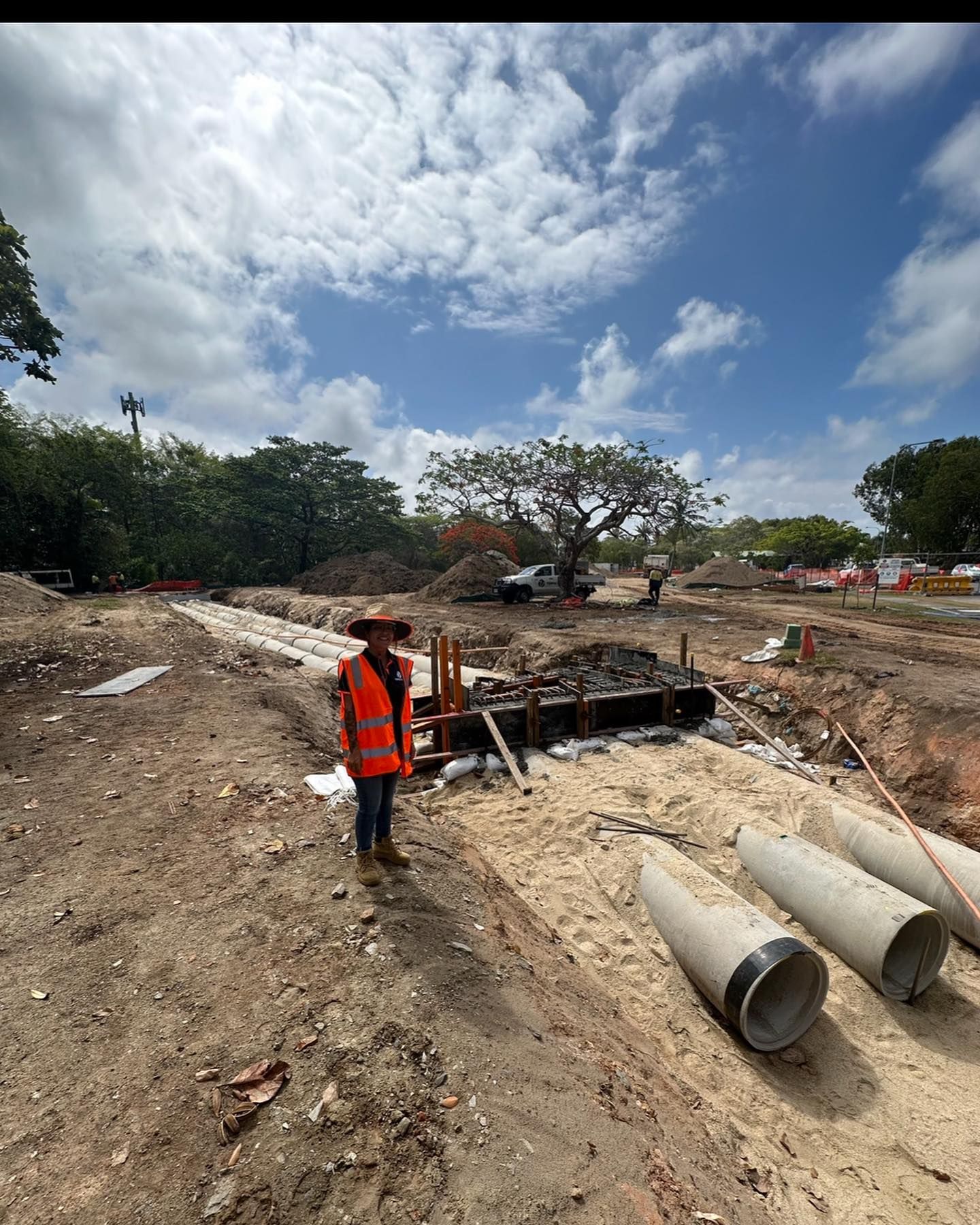 Construction Worker in Orange Vest Stands Near Excavated Area — Terranovus Earthworks & Plant Hire in Cairns City, QLD
