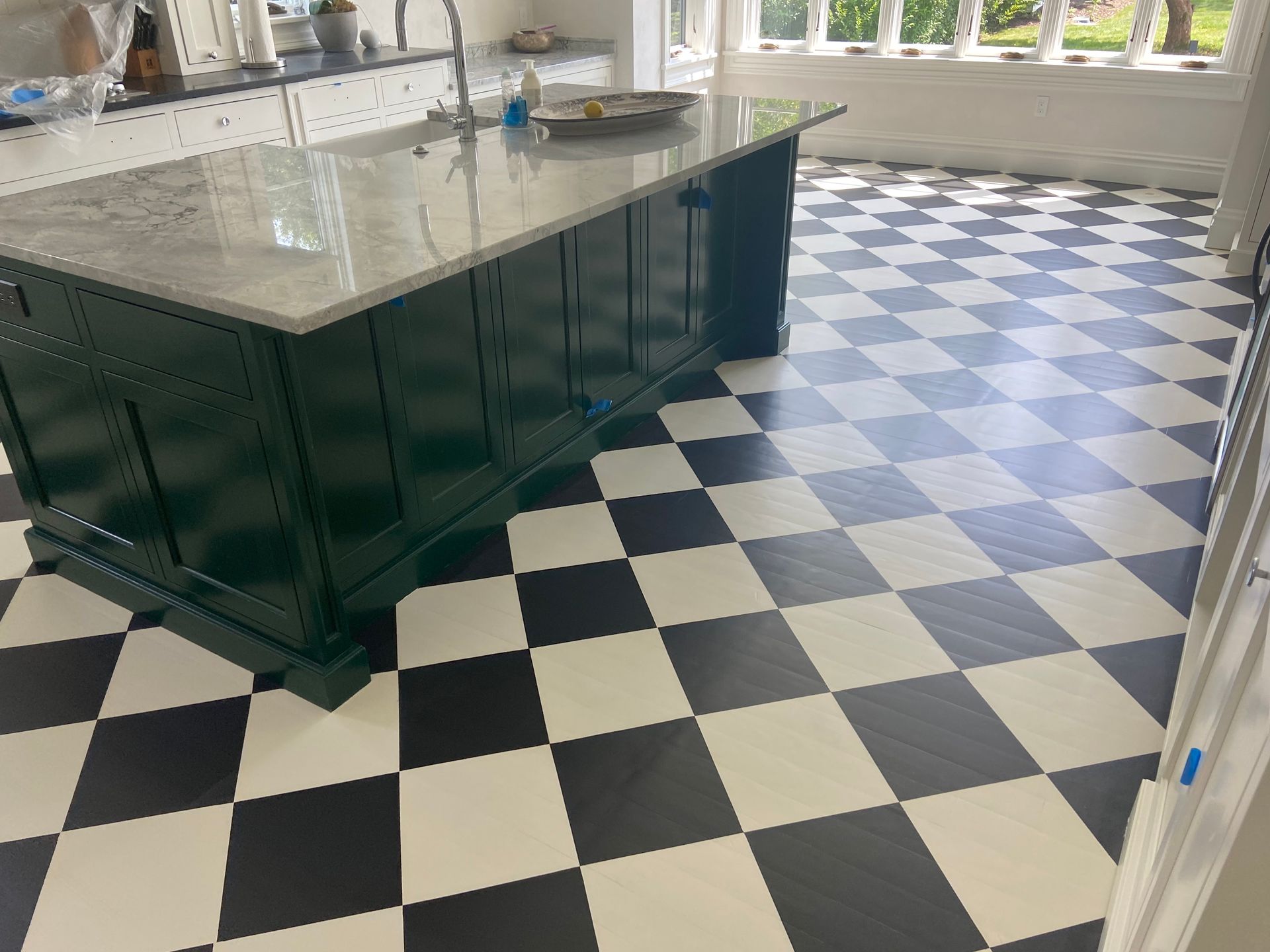 A kitchen with a black and white checkered floor
