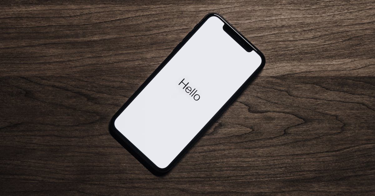 A cell phone is laying on a wooden table.