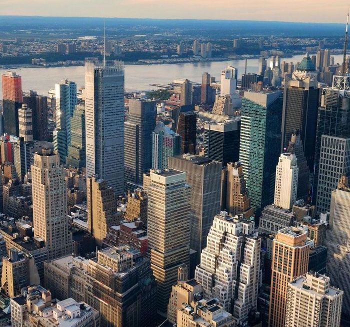 An aerial view of a city with a river in the background