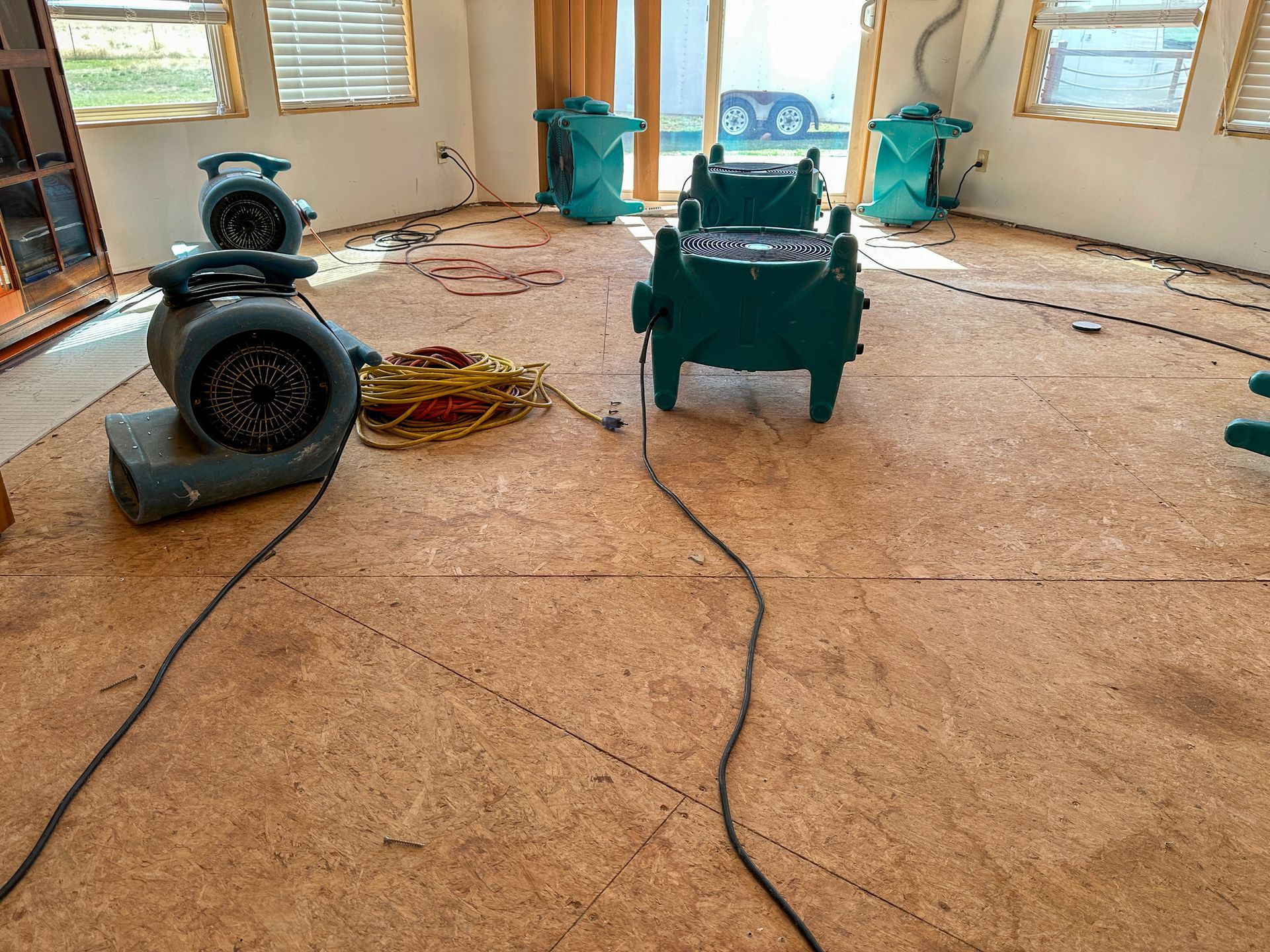 A group of air movers drying out a home in need of water restoration services.