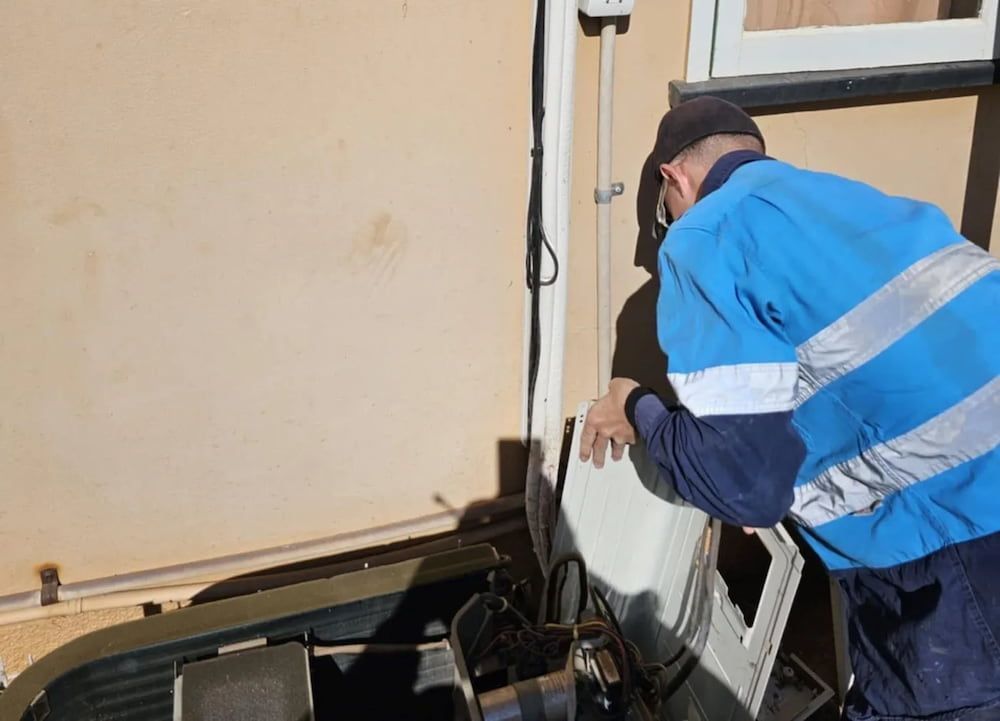 Person in Blue Work Shirt Working on a Machine — BNS Refrigeration Services in Healy, QLD