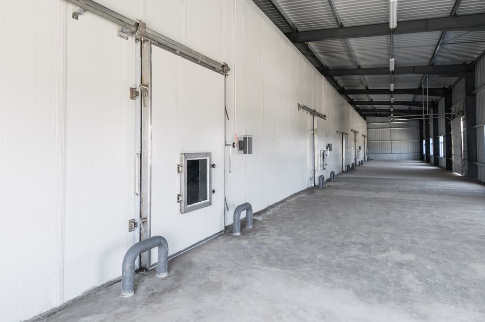 White Industrial Building Interior With Sliding Doors — BNS Refrigeration Services in Healy, QLD