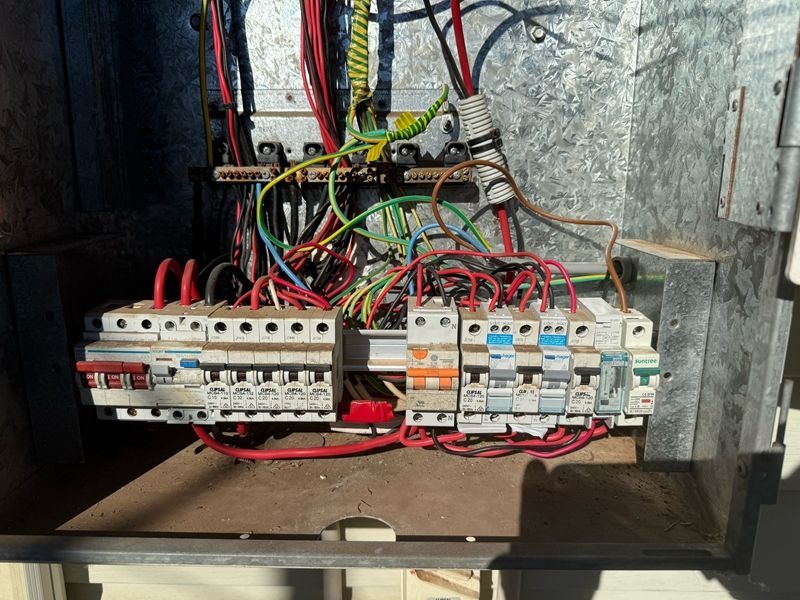 Electrical Panel With Various Colored Wires and Circuit Breakers — BNS Refrigeration Services in Healy, QLD
