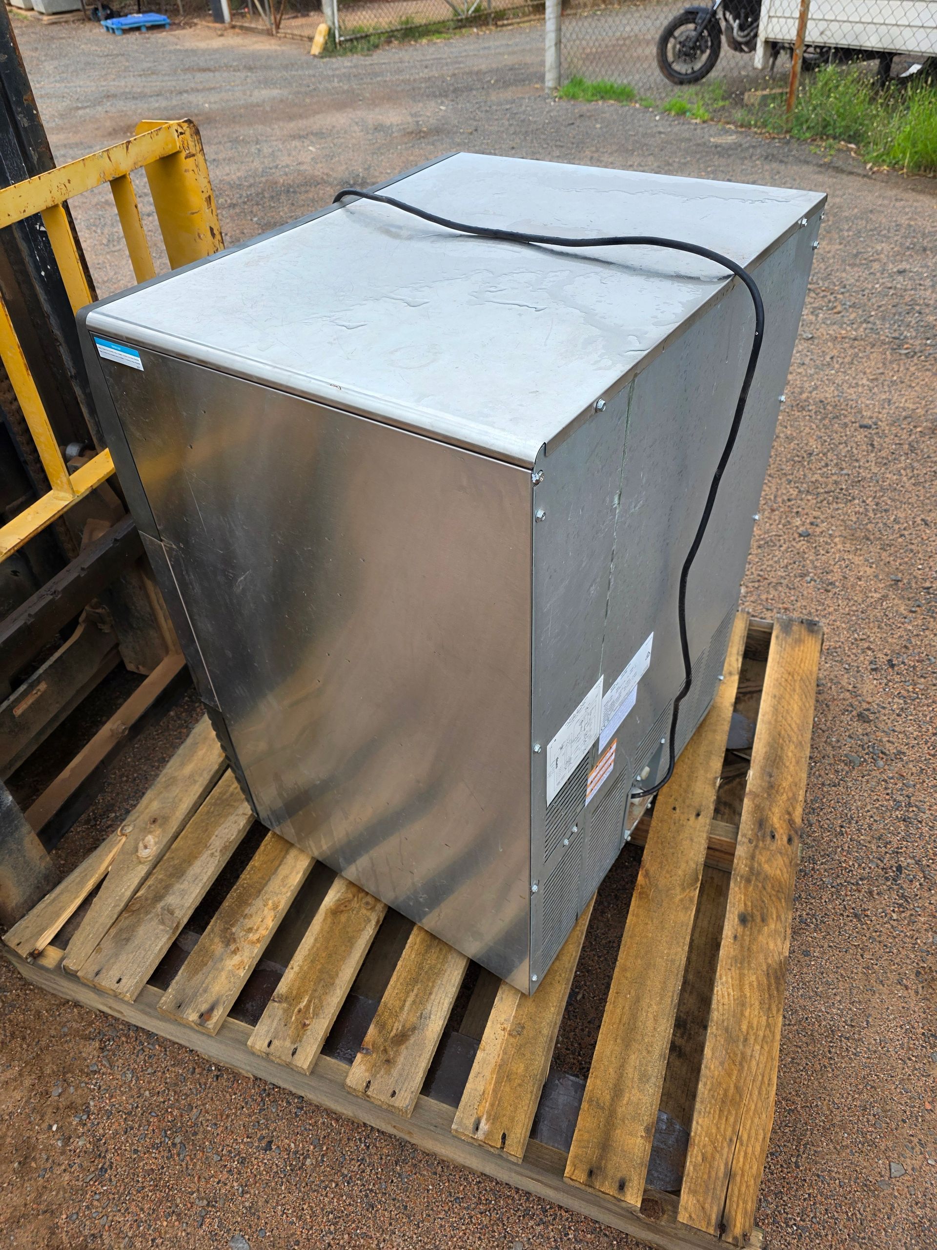 Stainless Steel Refrigerator on a Wooden Pallet — BNS Refrigeration Services in Healy, QLD