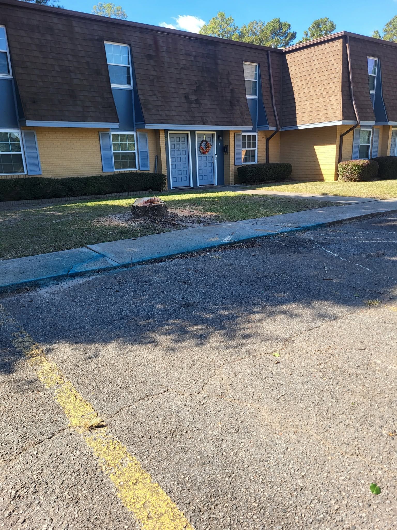 Apartment building exterior with a parking lot and yellow painted line in front