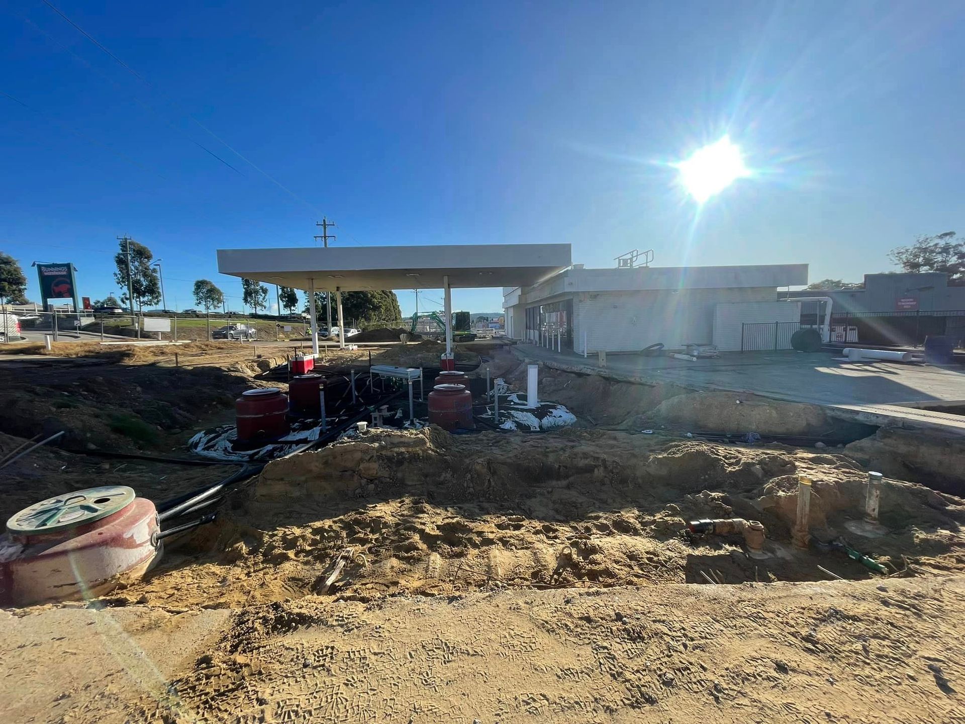 A Gas Station Is Being Built In The Middle Of A Dirt Field — BayCoast Electrical & Control Solutions in Braidwood, NSW