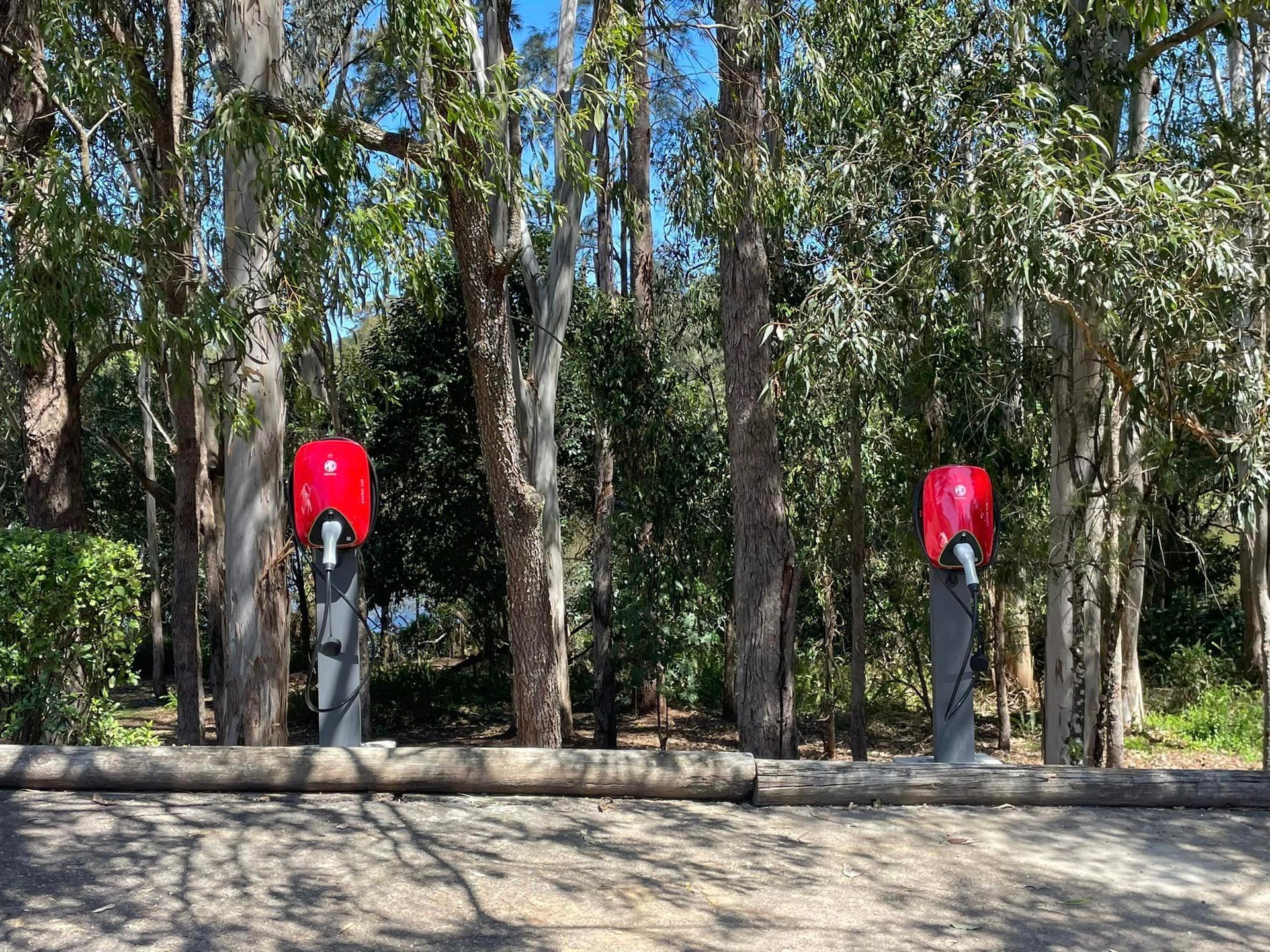 An Electric Car Is Being Charged At A Charging Station — BayCoast Electrical & Control Solutions in Maloneys Beach, NSW