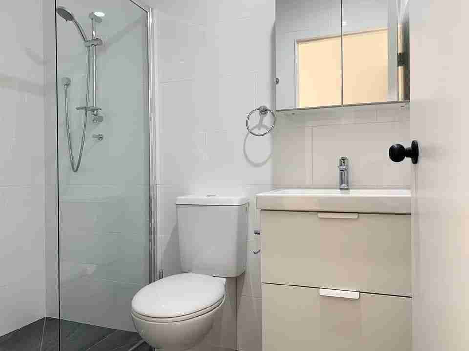 A Bathroom with A Toilet, Sink and Shower — Bay Coast Electrical & Control Solutions in Maloneys Beach, NSW