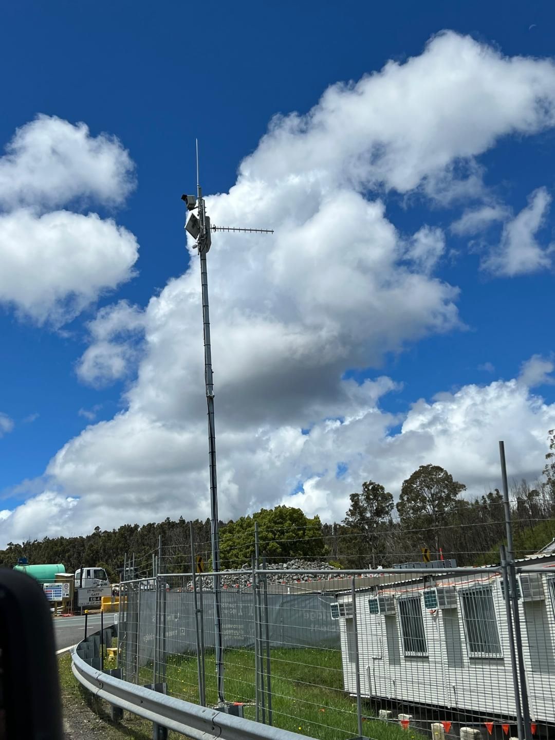 A Blue Sky With White Clouds And A Fence In The Foreground — BayCoast Electrical & Control Solutions in Maloneys Beach, NSW