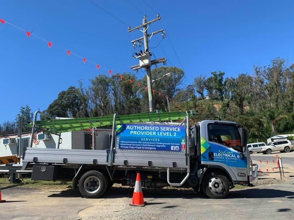 A Truck Is Parked In A Parking Lot Next To A Power Pole — BayCoast Electrical & Control Solutions in Sussex Inlet, NSW