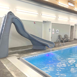 Indoor pool with gray waterslide.