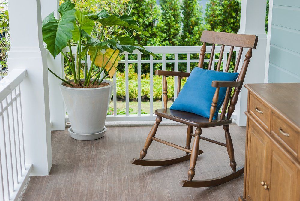 lone rocking chair on front porch