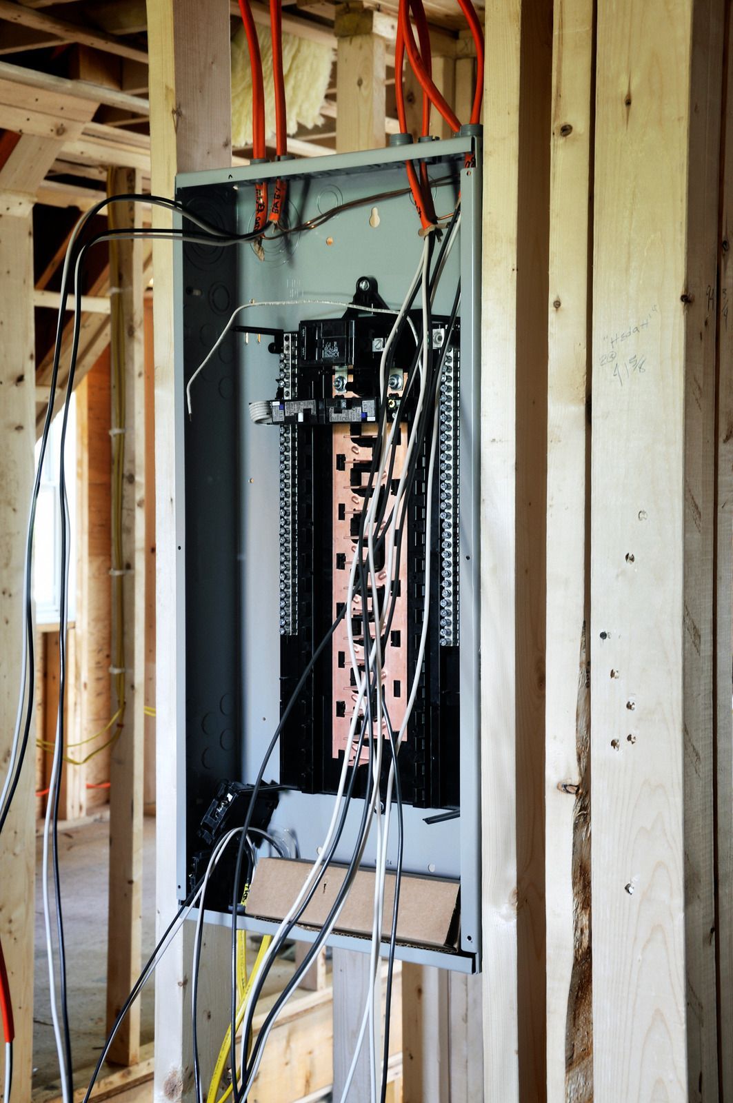 Electrical breaker panel installed in an unfinished wall framing