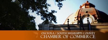 The copper dome of the Mississippi County Courthouse sits behind trees, above text reading Chamber of Commerce.