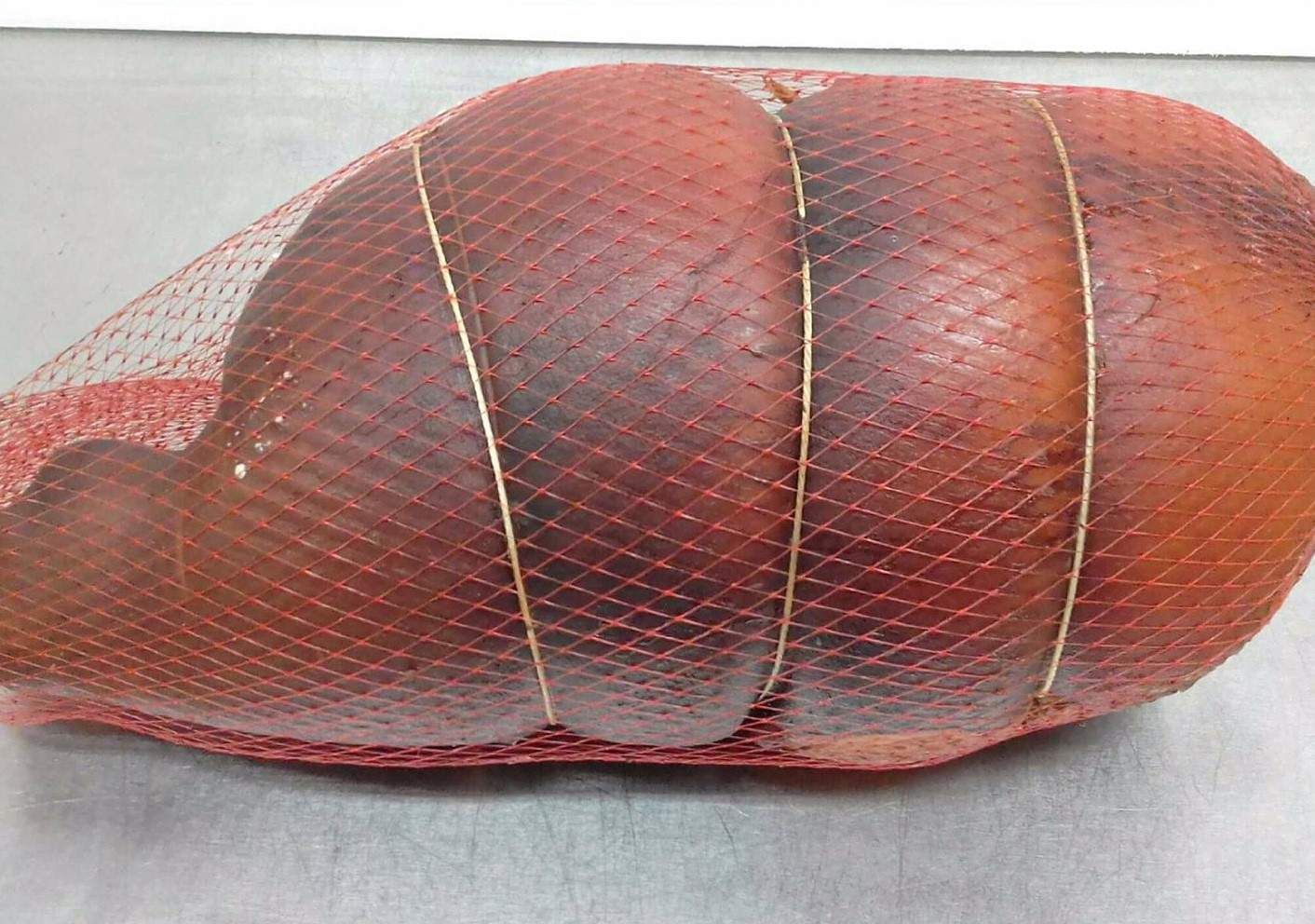 A Large Piece Of Meat Is Wrapped In A Mesh Bag — Edgeworth Meat & More in Edgeworth, NSW