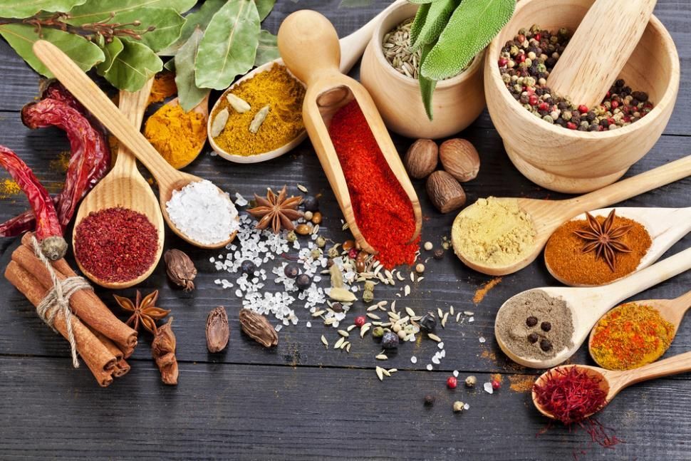 A Wooden Table Topped With Wooden Spoons Filled With Different Types Of Spices — Edgeworth Meat & More in Edgeworth, NSW