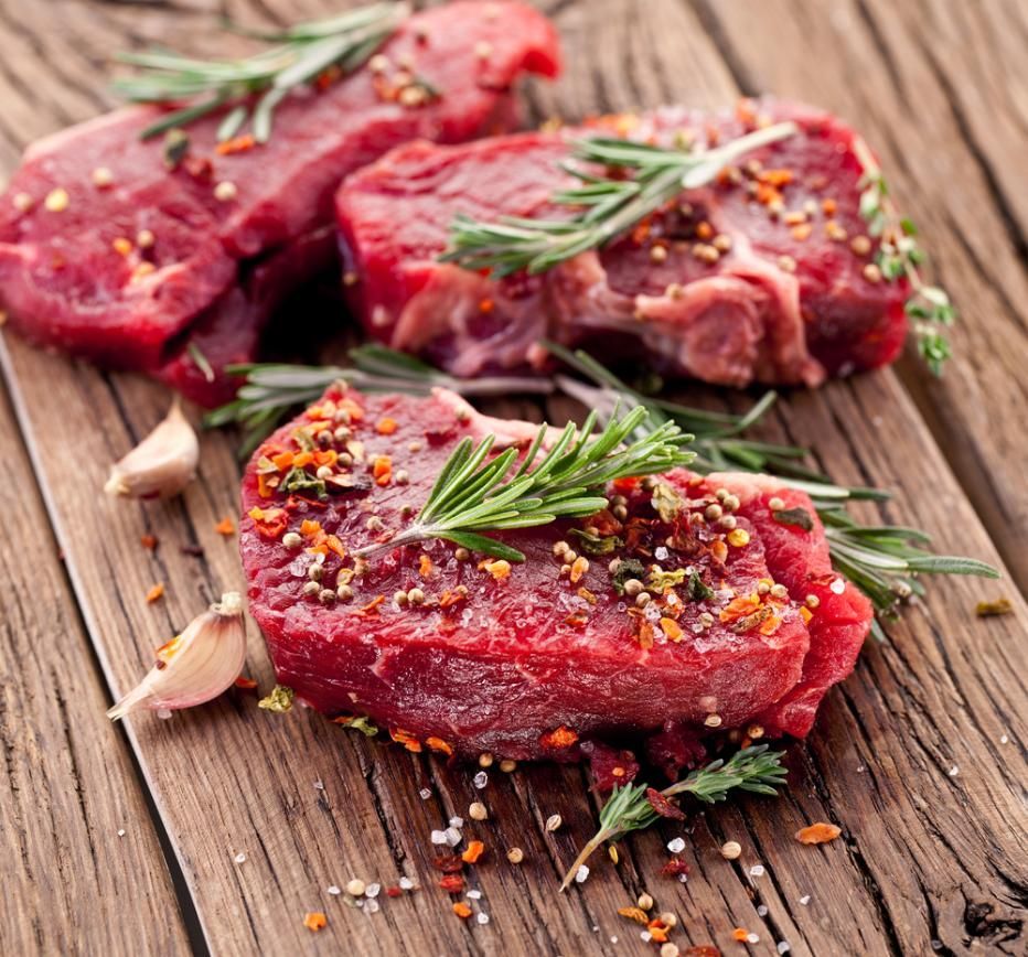Three Raw Steaks On A Wooden Cutting Board With Herbs And Spices — Edgeworth Meat & More in Edgeworth, NSW