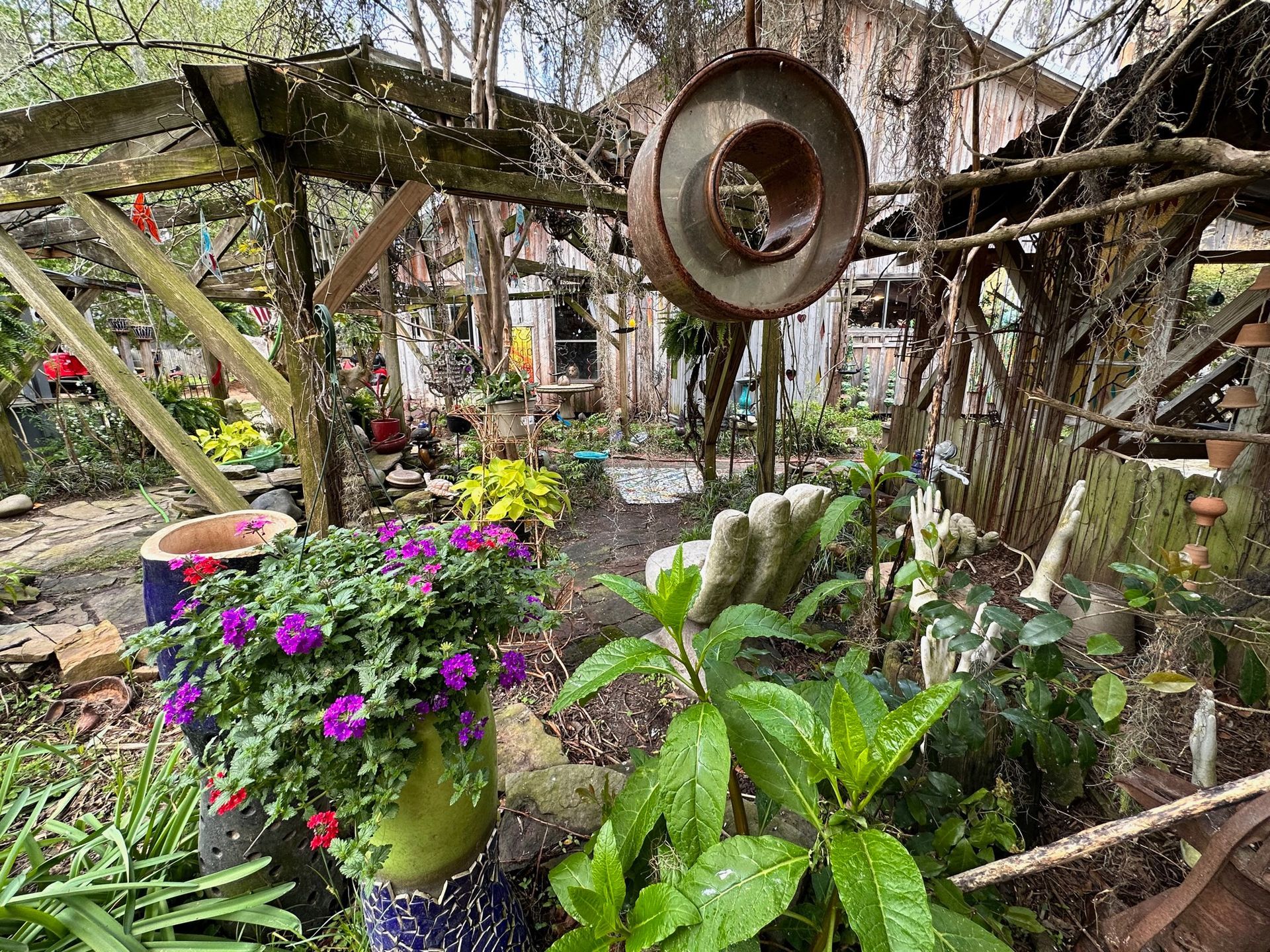 A garden filled with lots of potted plants and flowers.