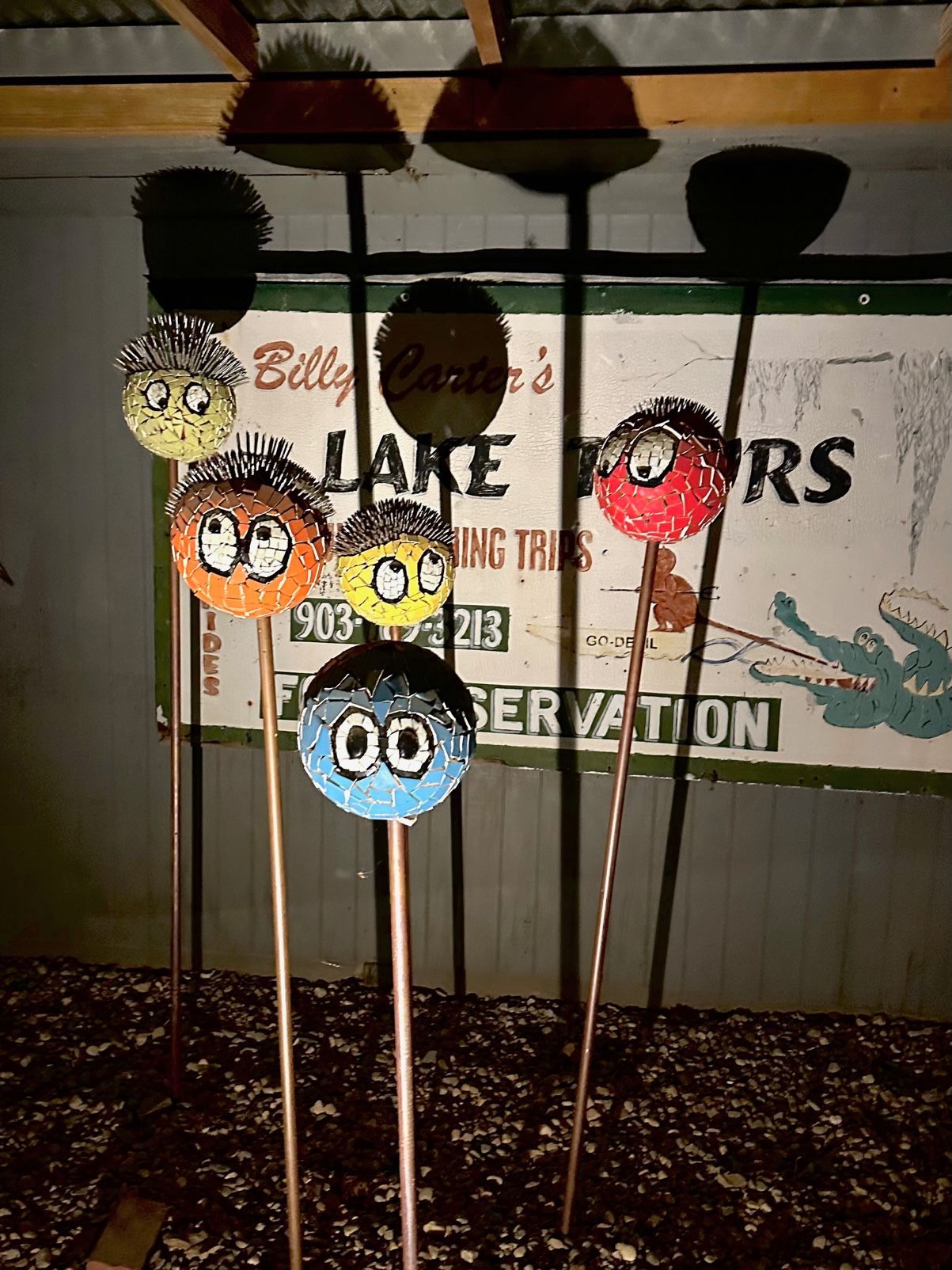 A bunch of brooms are lined up in front of a sign that says conservation