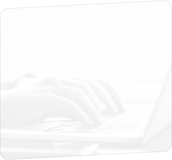 A close-up view of hands typing on a laptop keyboard.