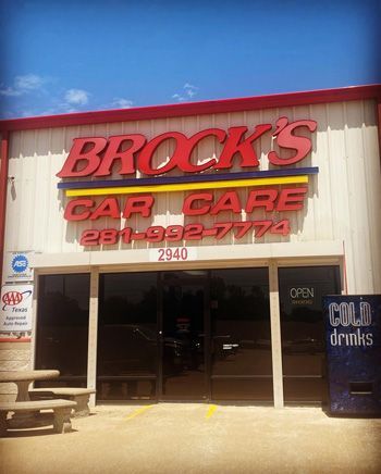 A storefront with red and blue signs for Brock's Car Care, displaying the phone number 281-992-7774 and address 2940.