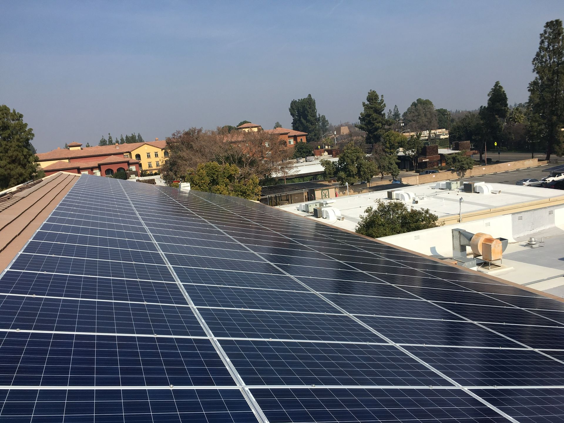 A row of solar panels on the roof of a building