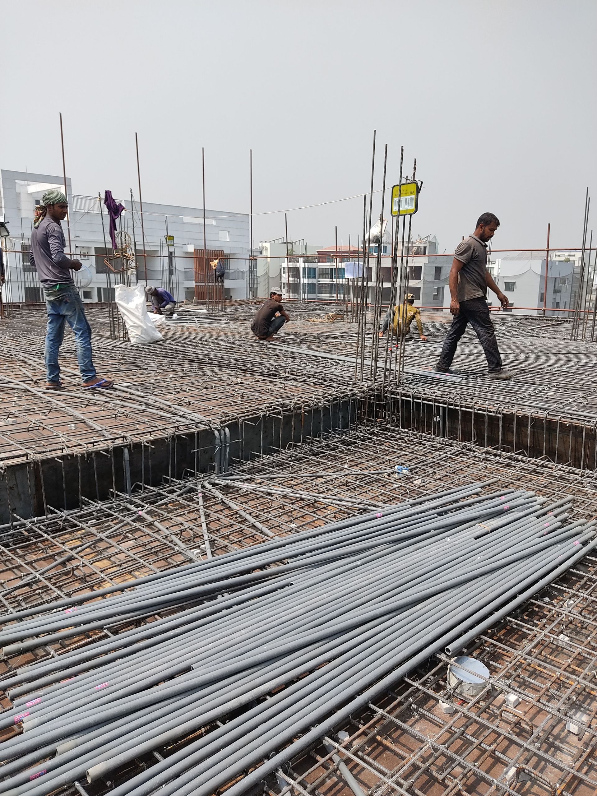 Construction crew working on rebar at a Texas job site, the kind of trade work that requires contractor license and permit bonds