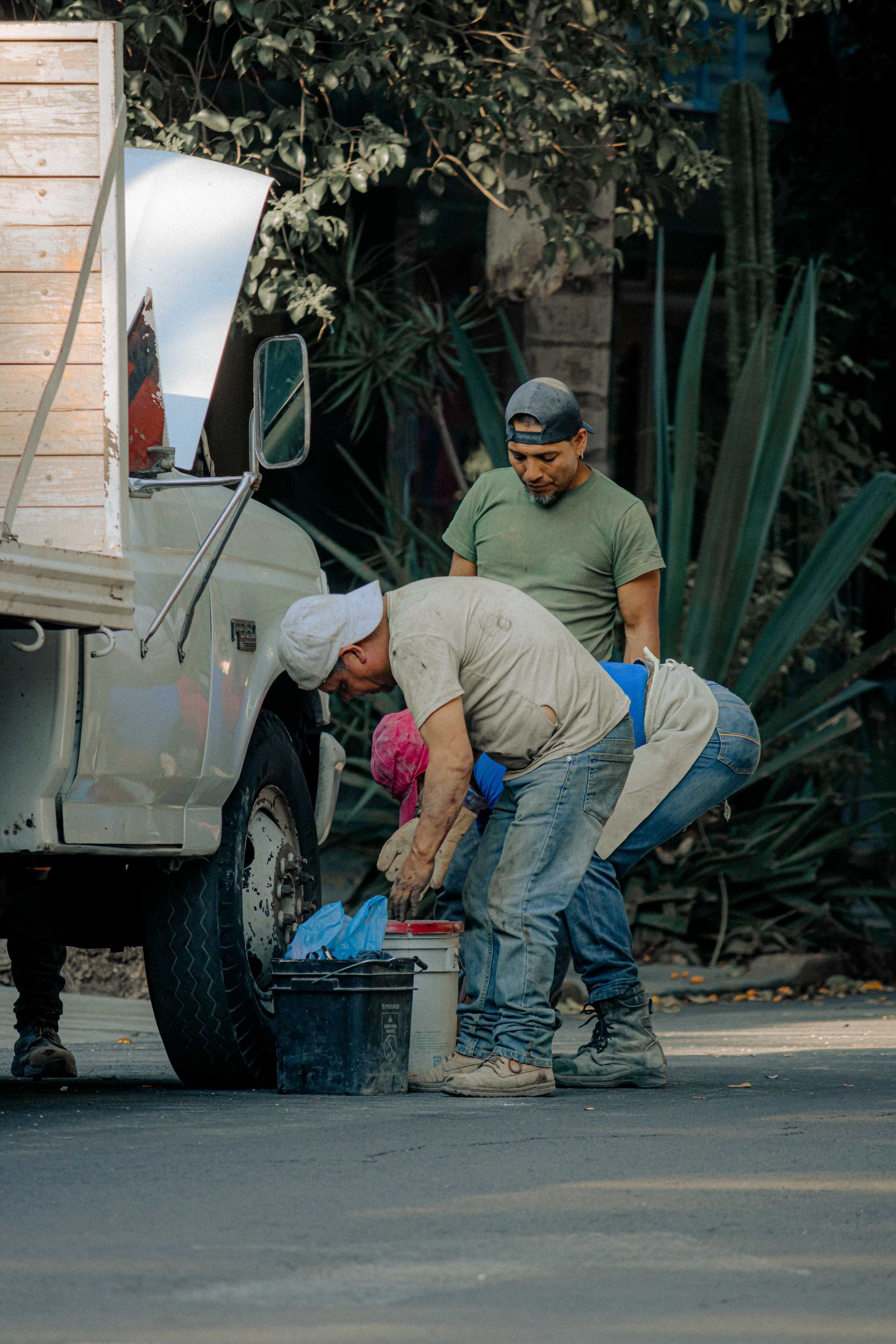 Two landscaping crew members working beside their truck in North Texas, the size of business cyber criminals still target