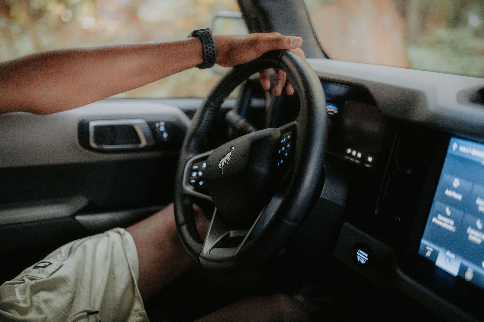 Driver's hands on the steering wheel while commuting through Dallas-Fort Worth traffic in North Texas