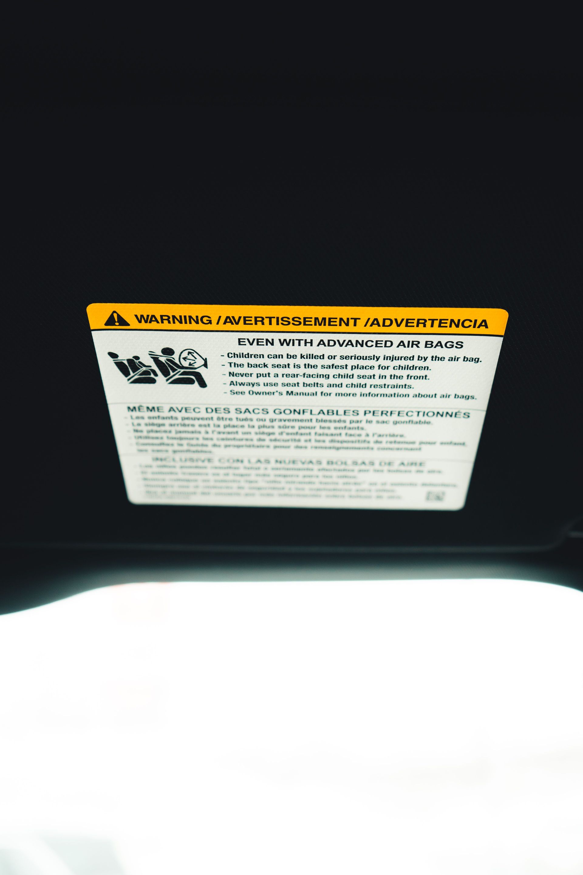 Close-up of a yellow certification label on a vehicle, the sticker that settles the CDL question