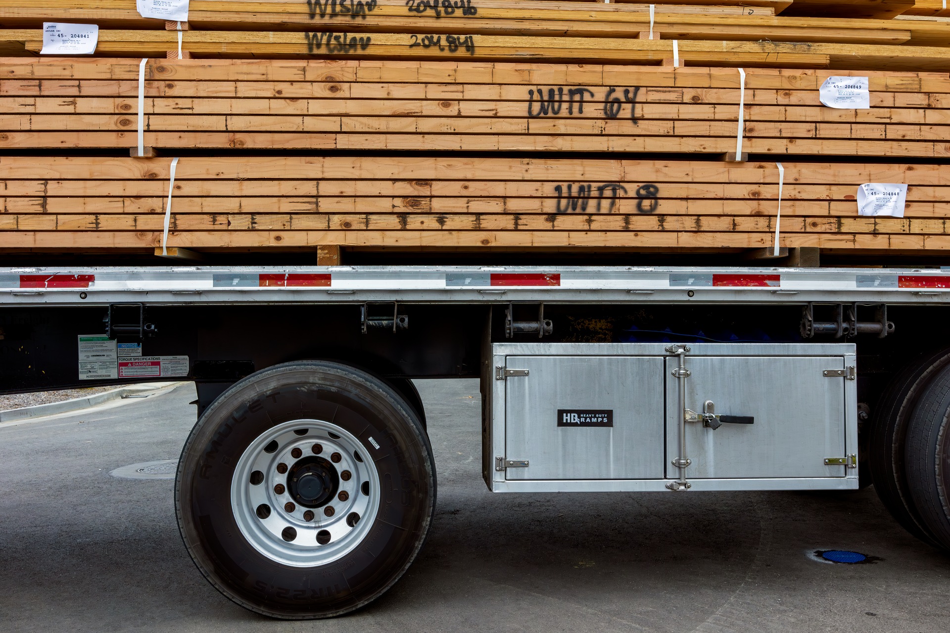 Flatbed trailer loaded with strapped lumber, a typical hot shot freight load