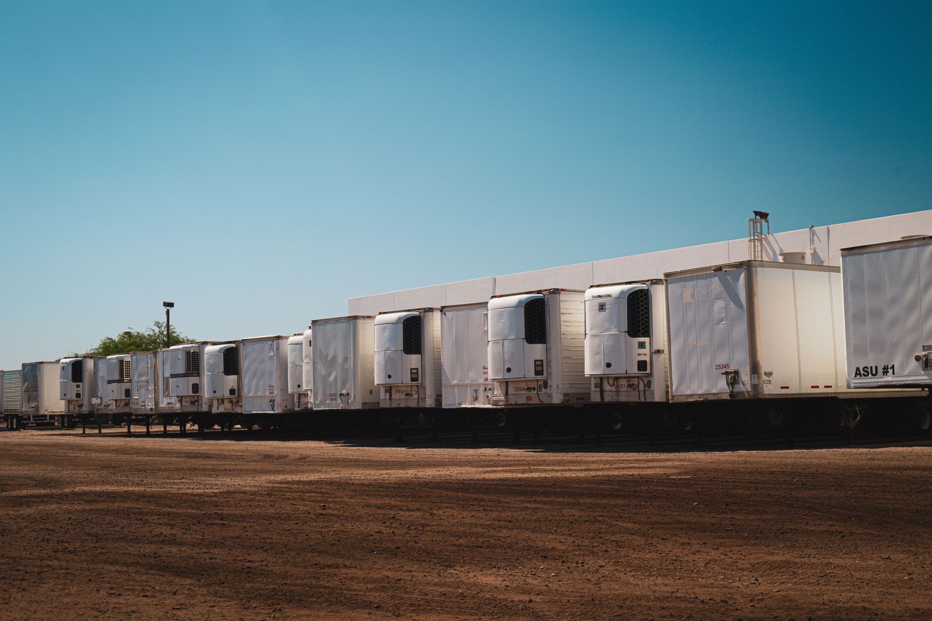 Semi tractors parked in rows at a North Texas trucking yard, the kind of growing fleet that outgrows