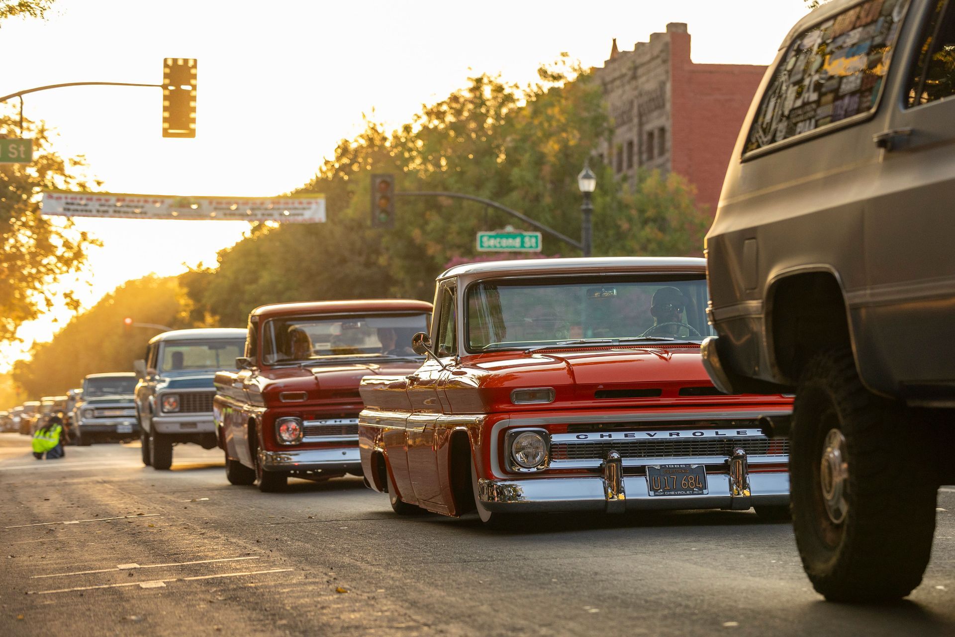 A lineup of restored classic trucks and cars at a Texas cruise-in car show