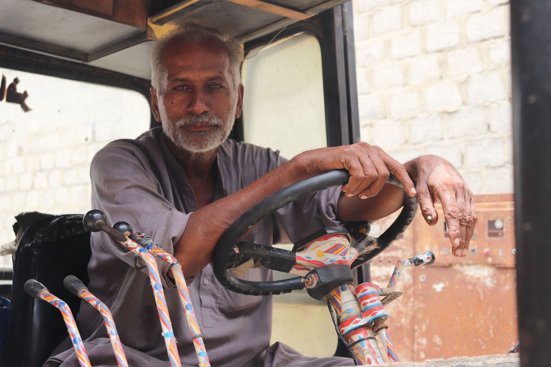 A trucker at the wheel of his cab, the driver whose actual lanes the radius on a trucking policy is supposed to describe