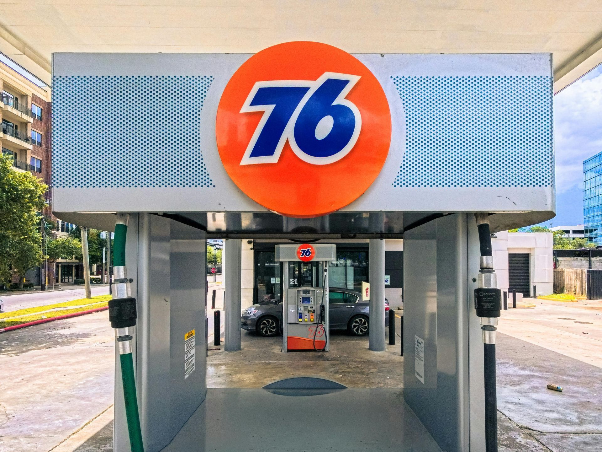 76 gas station canopy with orange-and-blue logo above fuel pumps