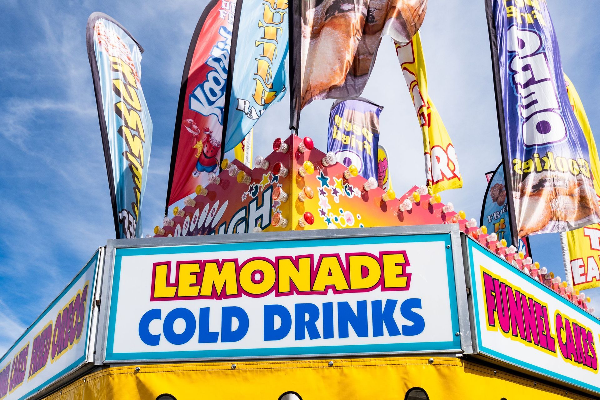 Concession trailer parked at a fairground with its awning open, ready for the weekend crowd