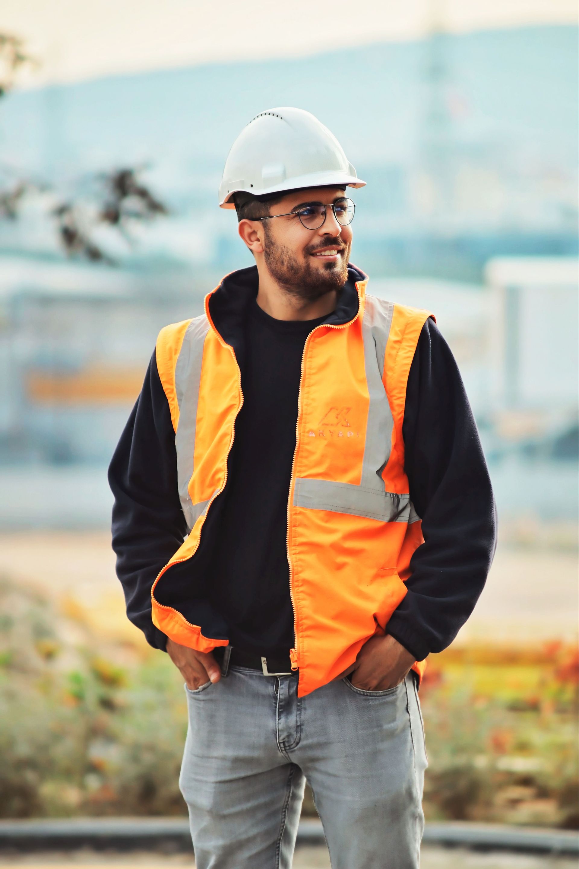 A construction worker in a hard hat and safety vest on a job site, the kind of paycheck LTD protects