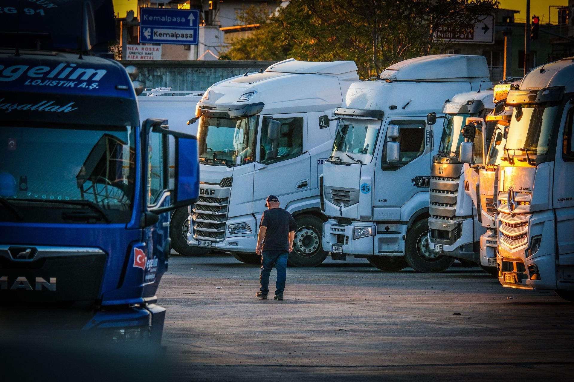 Newly licensed driver doing a pre-trip walkaround of a day cab at a North Texas truck stop on a