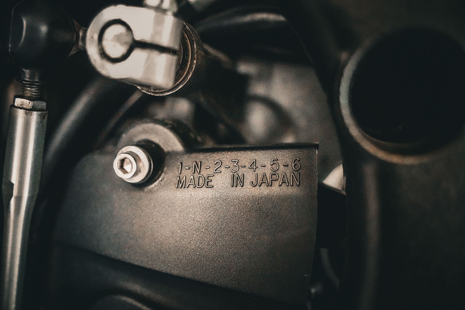 A riveted metal ID plate stamped with serial numbers, the kind of label that decides a coverage path