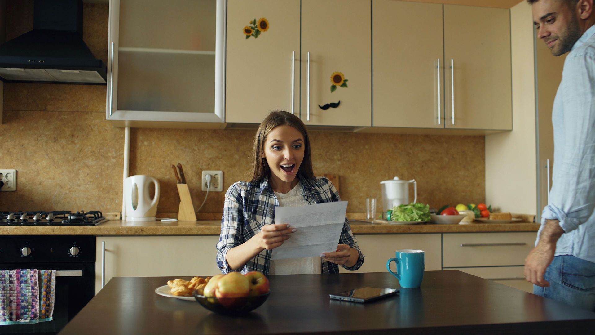 Homeowner reading an insurance non-renewal letter at the kitchen table of a North Texas home