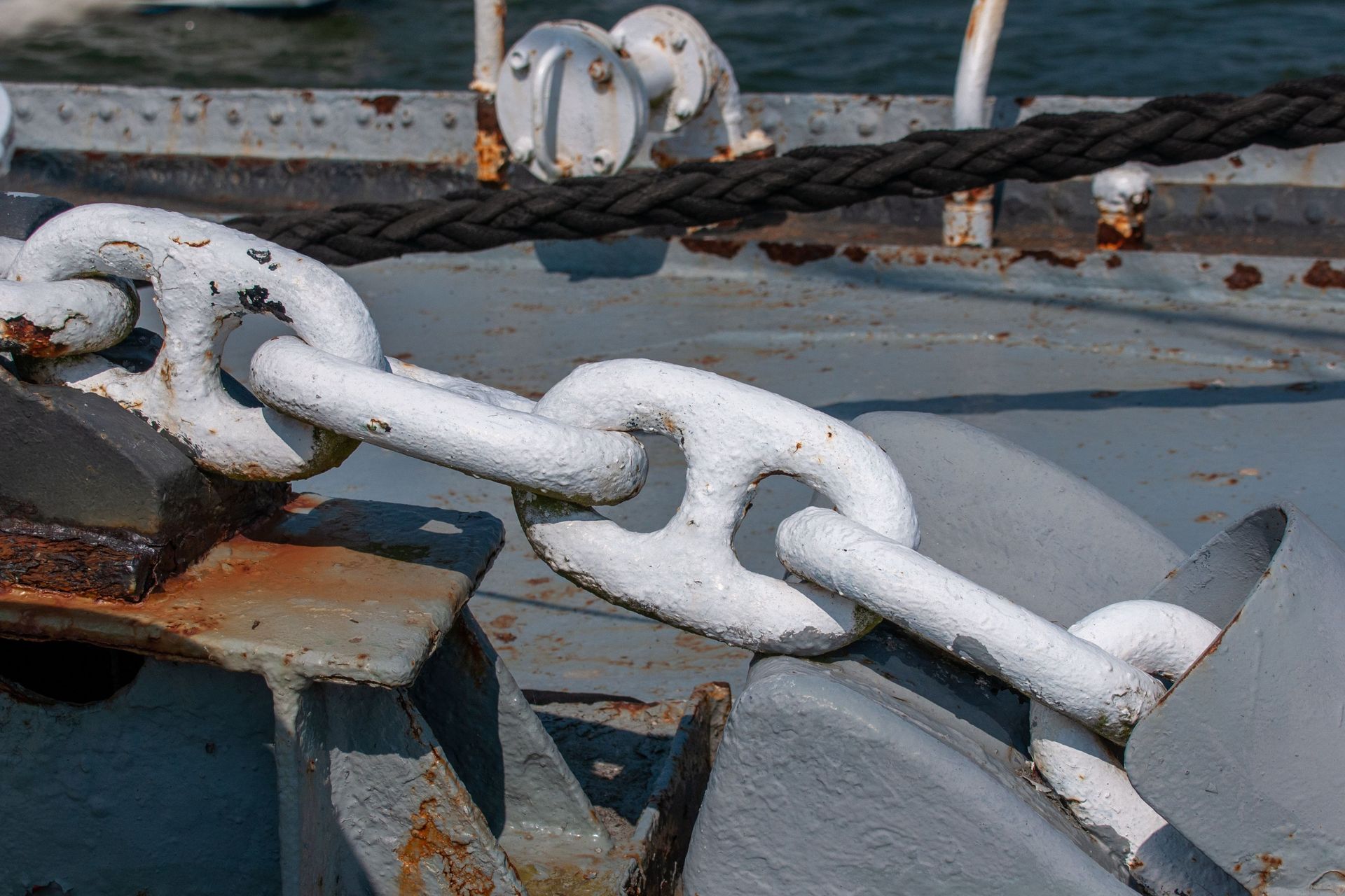 A tow strap and hook clamped to a car frame, the equipment point where on-hook coverage responds