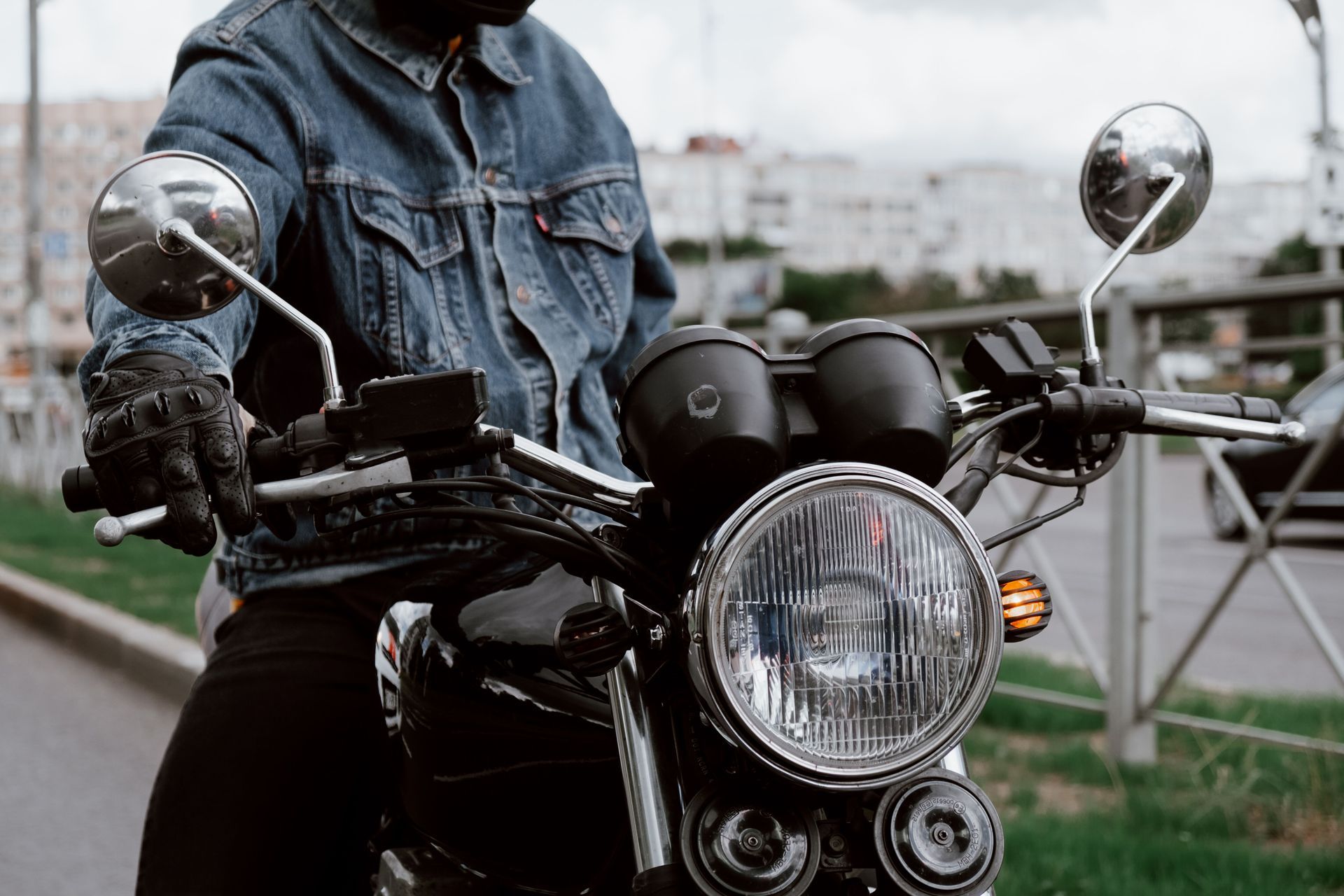 Close-up of a motorcycle handlebars and headlight, the kind of ride Texas motorcycle insurance is built to protect